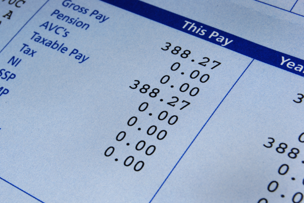 image of a paycheck stub to demonstrate the budgeting mistake of overestimating your income